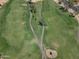 Expansive aerial shot of a well-kept golf course with manicured fairways, sand traps, and scenic landscaping at 9847 E Michigan Ave, Sun Lakes, AZ 85248