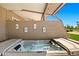 Relax in this outdoor hot tub with decorative art and a view of the community green space at 9847 E Michigan Ave, Sun Lakes, AZ 85248
