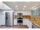 Bright kitchen features stainless steel appliances, white cabinets, and beautiful granite countertops at 9847 E Michigan Ave, Sun Lakes, AZ 85248