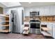 Kitchen boasting stainless steel appliances, granite countertops, and convenient pull-out shelving at 9847 E Michigan Ave, Sun Lakes, AZ 85248