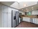 Bright, modern kitchen with stainless steel appliances, white cabinetry, granite countertops, and a skylight above at 9847 E Michigan Ave, Sun Lakes, AZ 85248