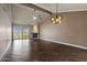 Spacious living room boasts a stone fireplace, wood-look tile flooring, and a vaulted ceiling at 9847 E Michigan Ave, Sun Lakes, AZ 85248