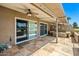 This covered patio features tile floors, ceiling fans, and a built-in grill, perfect for outdoor entertaining at 9847 E Michigan Ave, Sun Lakes, AZ 85248