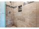 Close up of a tiled shower with glass door, tile accents, and recessed shelf at 9847 E Michigan Ave, Sun Lakes, AZ 85248