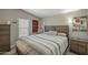 Bedroom with a high ceiling, wood furnishings, and striped bedding at 10951 N 91St Ave # 32, Peoria, AZ 85345