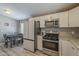 Eat in kitchen featuring granite countertops and stainless steel appliances at 10951 N 91St Ave # 32, Peoria, AZ 85345