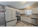 Modern kitchen with stainless steel appliances, granite counters, and white cabinets at 10951 N 91St Ave # 32, Peoria, AZ 85345