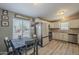 Open-concept kitchen and dining area with white cabinets, stainless appliances, and ample natural light at 10951 N 91St Ave # 32, Peoria, AZ 85345