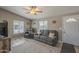 Cozy living room with neutral walls, ceiling fan and large windows with blinds at 10951 N 91St Ave # 32, Peoria, AZ 85345