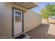 View of the shed's exterior, showing its door, painted siding, and the gravel surrounding it at 10951 N 91St Ave # 32, Peoria, AZ 85345