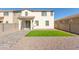 A well-maintained backyard with gravel landscaping, a small strip of lawn, and a covered patio at 10983 W Mckinley St, Avondale, AZ 85323