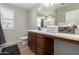 Bathroom featuring a wood vanity, ample counter space, and lots of natural light at 10983 W Mckinley St, Avondale, AZ 85323