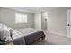 Well-lit bedroom with carpeted floors, queen bed, plantation shutters, and neutral decor at 10983 W Mckinley St, Avondale, AZ 85323