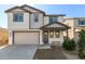 Charming two-story home with landscaped yard, a covered entryway, and an attached two-car garage at 10983 W Mckinley St, Avondale, AZ 85323