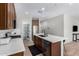 Spacious kitchen featuring stainless appliances, a large island, and brown cabinetry at 10983 W Mckinley St, Avondale, AZ 85323