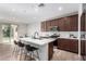 Bright kitchen features a central island with seating and stainless steel appliances at 10983 W Mckinley St, Avondale, AZ 85323