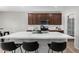 Modern kitchen with stainless steel appliances, dark wood cabinets, and a large center island at 10983 W Mckinley St, Avondale, AZ 85323