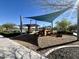 Community playground featuring a shade structure and wooden play structure at 10983 W Mckinley St, Avondale, AZ 85323