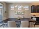 Elegant dining area with modern lighting and comfortable seating for six at 132 E El Prado Dr, Queen Creek, AZ 85140