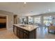 Open kitchen with a center island that flows into the living and dining areas at 132 E El Prado Dr, Queen Creek, AZ 85140