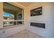 Covered patio with outdoor furniture, outdoor fireplace, television, and glass windows at 132 E El Prado Dr, Queen Creek, AZ 85140