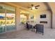 Covered patio with outdoor furniture, outdoor fireplace and television at 132 E El Prado Dr, Queen Creek, AZ 85140
