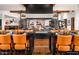 Contemporary restaurant featuring a large communal table with decorative fireplace and accents at 132 E El Prado Dr, Queen Creek, AZ 85140