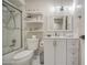 Well-lit bathroom showcasing a shower over tub, white vanity with storage, and open shelving at 1529 W Wickieup Ln, Phoenix, AZ 85027