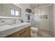 Modern bathroom featuring a glass-enclosed shower, a stylish vanity, and decorative accents at 1529 W Wickieup Ln, Phoenix, AZ 85027