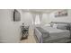 Modern bedroom featuring soft, gray tones, a large bed, and a dedicated workstation area at 1529 W Wickieup Ln, Phoenix, AZ 85027