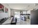 Spacious eat-in kitchen featuring modern stainless-steel appliances, a breakfast bar, white cabinets, and access to the backyard at 1529 W Wickieup Ln, Phoenix, AZ 85027