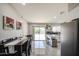 Stylish kitchen featuring stainless steel appliances, a breakfast bar, white cabinetry and an adjacent dining area at 1529 W Wickieup Ln, Phoenix, AZ 85027