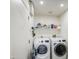 Practical laundry room featuring a washer, dryer, and ample shelving for storage, ideal for home organization at 1529 W Wickieup Ln, Phoenix, AZ 85027