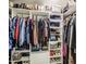 Spacious walk-in closet with organized shelving for shoes, folded clothes, and hanging apparel at 1529 W Wickieup Ln, Phoenix, AZ 85027