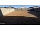 The backyard has a fresh layer of topsoil and a block fence at 15773 W Beryl Ave, Waddell, AZ 85355