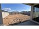 View of the property's backyard and perimeter walls from the covered patio at 15773 W Beryl Ave, Waddell, AZ 85355