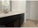 Bathroom vanity with dark cabinets, granite countertop and a brushed metal faucet at 15773 W Beryl Ave, Waddell, AZ 85355