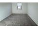 Bright bedroom with neutral carpet, natural light, and freshly painted white walls at 15773 W Beryl Ave, Waddell, AZ 85355