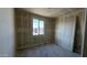 View of the bedroom with neutral walls and natural light from window at 15773 W Beryl Ave, Waddell, AZ 85355