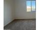 Bedroom featuring neutral carpet, window and freshly painted walls at 15773 W Beryl Ave, Waddell, AZ 85355