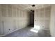 View of unfinished bedroom with walls covered in drywall and doorway leading into an en suite at 15773 W Beryl Ave, Waddell, AZ 85355