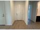 A home's entryway with wood look tile, white walls, and a white front door at 15773 W Beryl Ave, Waddell, AZ 85355