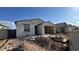 New single-story home with stucco exterior, tile roof and open garage at 15773 W Beryl Ave, Waddell, AZ 85355