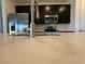 Modern kitchen with quartz countertops, backsplash, stainless appliances and dark cabinets at 15773 W Beryl Ave, Waddell, AZ 85355