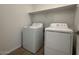 Efficient laundry room with modern washer and dryer and useful shelving at 15773 W Beryl Ave, Waddell, AZ 85355