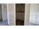 A large laundry room boasts wood floors, and shelving at 15773 W Beryl Ave, Waddell, AZ 85355