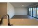 Bright living room with wood-look floors and large sliding glass doors at 15773 W Beryl Ave, Waddell, AZ 85355