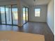 Bright living room with wood-look floors, sliding glass doors and lots of light at 15773 W Beryl Ave, Waddell, AZ 85355