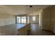 Spacious unfinished living room featuring stylish flooring, drywall walls, and sliding door access to the backyard at 15773 W Beryl Ave, Waddell, AZ 85355