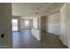 Unfinished living room featuring stylish flooring, drywall walls, and access to the backyard at 15773 W Beryl Ave, Waddell, AZ 85355